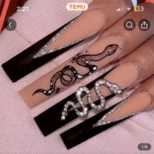 a screenshot of a woman 's nails with a snake design