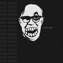 a man wearing glasses and a black shirt is smiling
