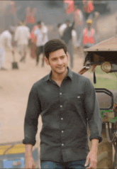 a man in a black shirt stands in front of a jeep