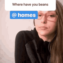 a woman wearing glasses and a sign that says where have you beans @ homes