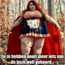 a woman dressed as little red riding hood is standing in a forest .