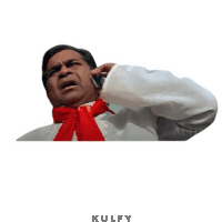 a man with a red scarf around his neck is talking on a cell phone with the word kulfy below him