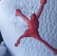 a close up of a red air jordan logo on a white blanket .