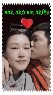 a man kissing a woman on the cheek with the words anh nho em nhieu in green