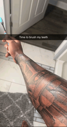a person with a tattoo on their arm is brushing their teeth with a toothbrush