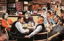 a group of men are sitting around a table in a diner with joker and the joker .