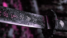 a samurai sword with chinese writing on the blade