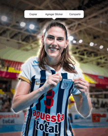 a woman wearing a jersey that says " apuesta total "