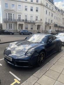 a blue sports car with the license plate sah666 is parked on the side of the road