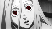 a close up of a person 's face with red eyes .