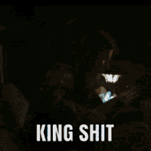 a dark background with the words king shit written on it