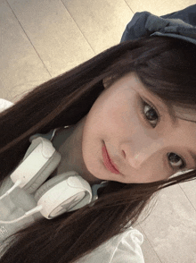 a close up of a girl wearing headphones and a hat