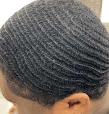 a close up of a person 's hair with a wave pattern