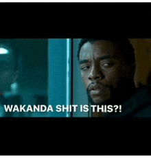 a man is looking out a window with the words wakanda shit is this on the bottom