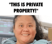 a woman is smiling in front of a sign that says ' this is private property '