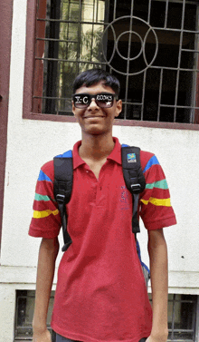 a boy wearing sunglasses that say x-c rocks smiles for the camera