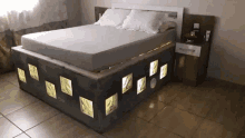 a bed with a mattress and a nightstand in a bedroom