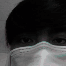 a close up of a person wearing a medical mask