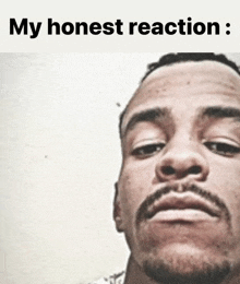 a close up of a man 's face with the words " my honest reaction " below it