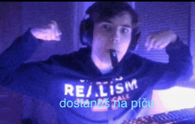 a man wearing headphones and a shirt that says " realism " on it