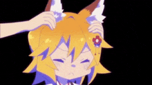 a close up of a person putting a fox ear on a person 's head .