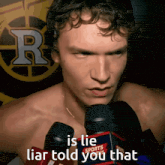 a shirtless man is talking into a sports radio microphone