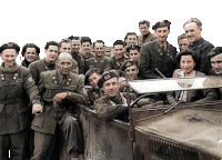 a group of soldiers are posing for a picture in front of a vehicle