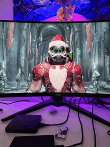 an aoc computer monitor displays a video game with a santa character on the screen