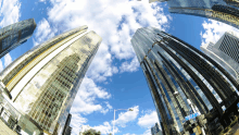 looking up at a city skyline with a sign that says ' first street '