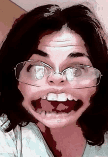 a woman wearing glasses makes a funny face with her mouth open