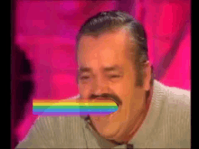 a man with a rainbow in his mouth is laughing .