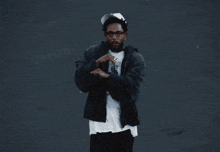 a man wearing a black jacket and a white t-shirt with a picture of a baby on it