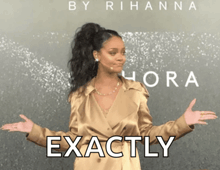a woman with her arms outstretched is standing in front of a poster that says exactly