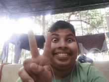 a young boy is making a peace sign with his fingers