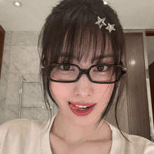 a close up of a woman wearing glasses with three stars on her hair