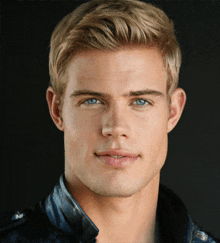 a young man with blonde hair and blue eyes