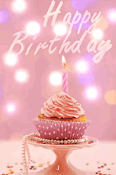 a pink cupcake with a pink frosting and a candle with the letter j on the bottom
