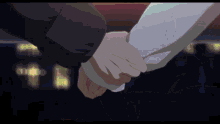 a man and woman holding hands in a dark room