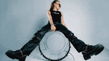 a woman is sitting on top of a drum .