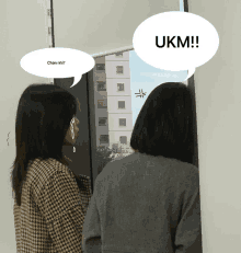 two women standing next to each other with one saying ukm