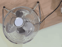 a silver fan is hanging from the ceiling