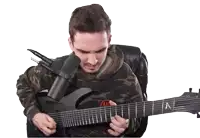 a man playing a guitar with a microphone attached to his neck