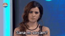 a woman is looking at the camera with the words sana mi sorcam written on her face .