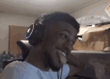 a man wearing headphones is sticking his tongue out while making a funny face .