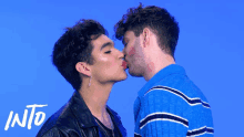 two men kissing in front of a blue background with the word into on the bottom