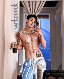 a shirtless man is taking a picture of himself in the mirror .