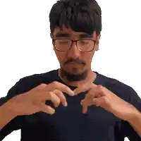 a man with glasses and a beard making a heart shape with his hands
