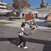 a man in a striped shirt is jumping in the air
