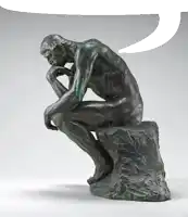 a statue of a man sitting on a rock with a speech bubble above him