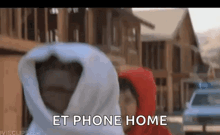 et from the movie et the extraterrestrial is wrapped in a blanket and talking to someone .